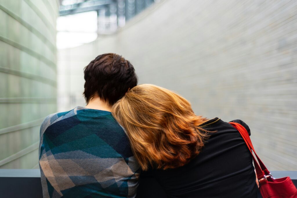 couples sad resting head on one's shoulder