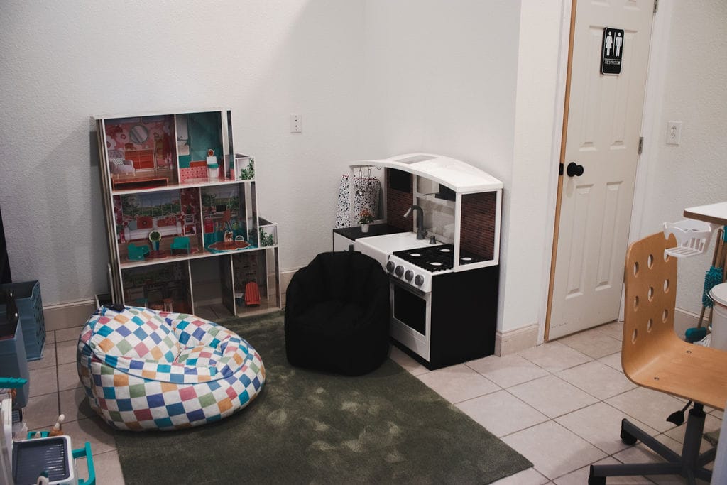 Play therapy room with toys and a play kitchen at Social House Wellness.