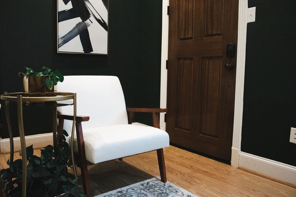 White chair and side table in a Social House counseling office.